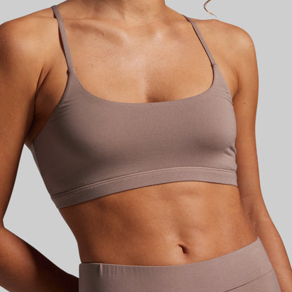 Brown sports bra and leggings on a plain background