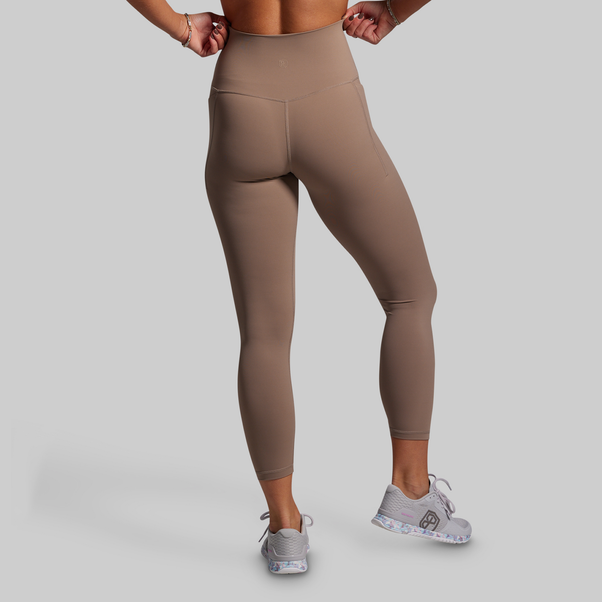 Beige leggings worn by a person on a plain background
