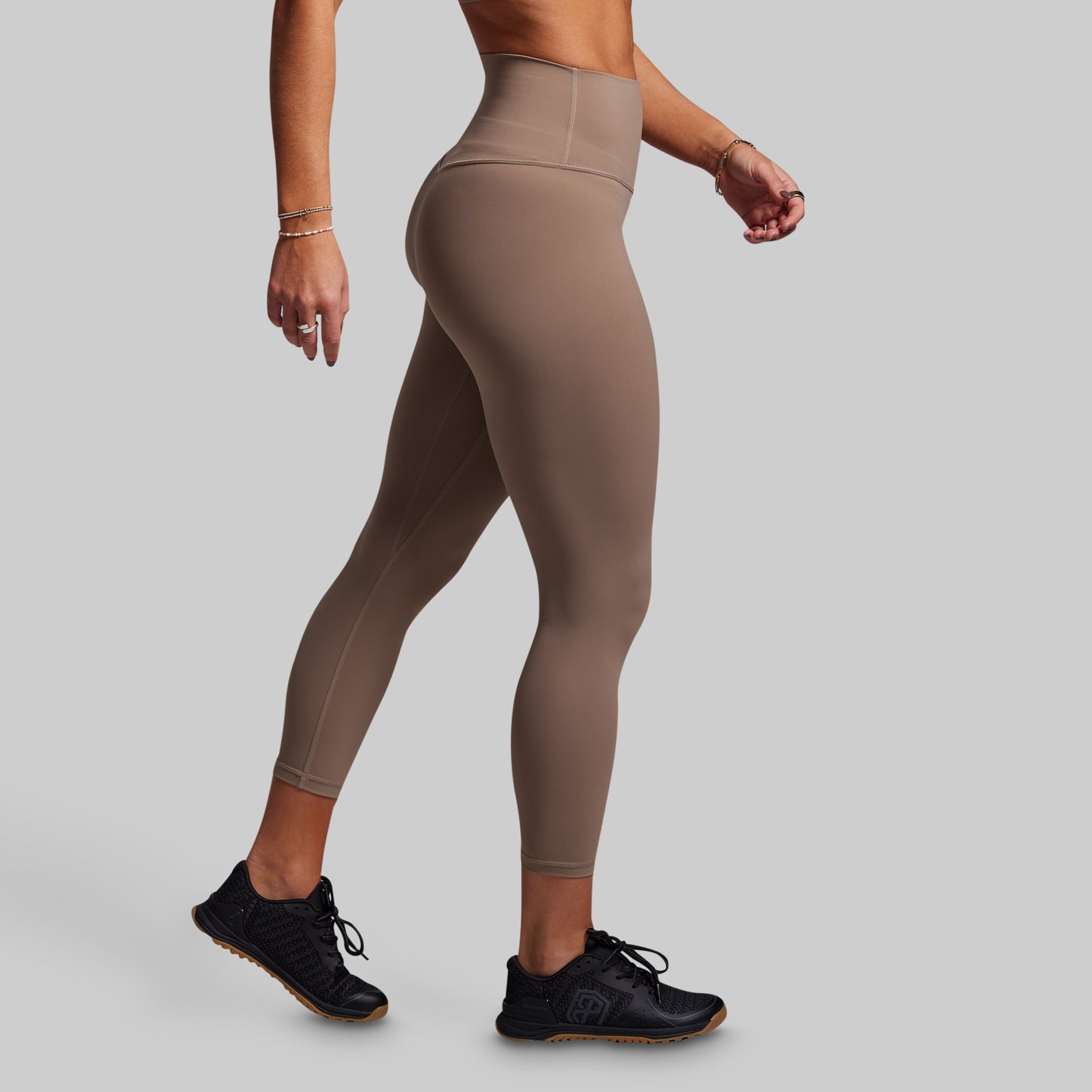 Beige leggings worn by a person on a plain background